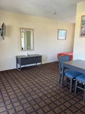 a waiting room with tables and chairs and a mirror at Star Motel in San Diego