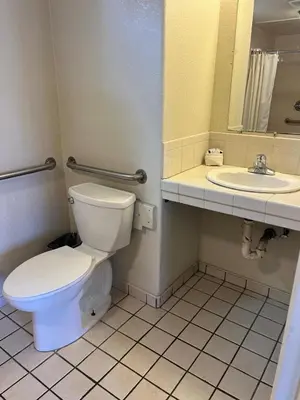 a bathroom with a toilet and a sink at Star Motel in San Diego