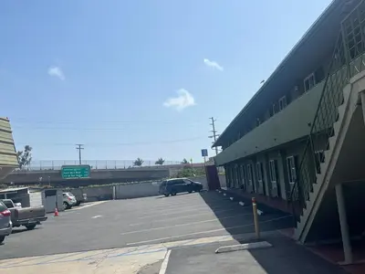 a parking lot with a car parked next to a building at Star Motel in San Diego