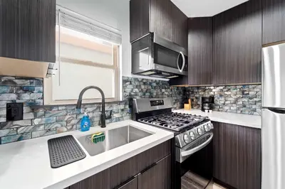 a kitchen with a stove and a sink at The Neon Elm Hotel in San Diego
