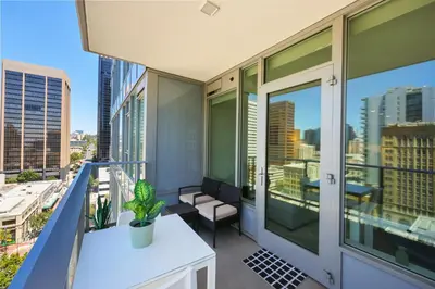 an apartment balcony with a view of the city at NEW Upscale Downtown San Diego Stay Queen Bed Pool & Sauna in San Diego