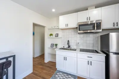 a kitchen with white cabinets and a stainless steel refrigerator at Beautiful cozy home in San Diego in San Diego