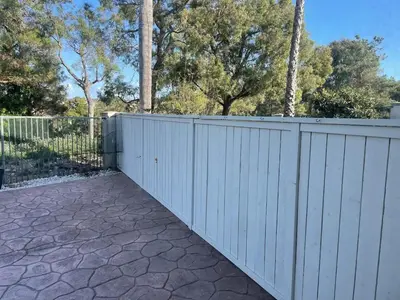a white fence in a driveway with trees at Family-Friendly Sunny SD Escape, Sleeps 8, Beach, Zoo, Downtown & Convention Center in San Diego
