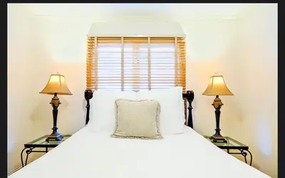 a bedroom with a large bed with two lamps at Spacious 5BD Ocean Views Pool Jacuzzi in San Diego