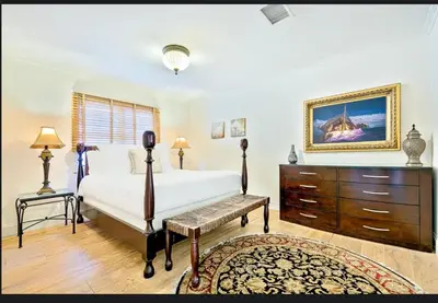 a bedroom with a bed and a dresser and a dresser at Spacious 5BD Ocean Views Pool Jacuzzi in San Diego