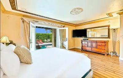 a bedroom with a large white bed and a television at Spacious 5BD Ocean Views Pool Jacuzzi in San Diego