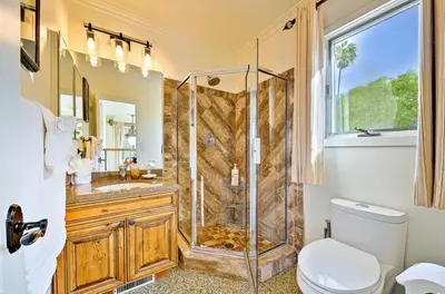 a bathroom with a shower and a toilet and a sink at Spacious 5BD Ocean Views Pool Jacuzzi in San Diego