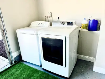 a washer and dryer sitting in a room at Xlnc Exotic home Poway in Poway