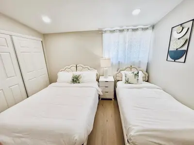 a bedroom with two beds and a window at Xlnc Exotic home Poway in Poway