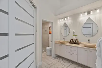 a bathroom with two sinks and a mirror at Carlsbad Retreat by the Sea -30-Night Minimum in Carlsbad