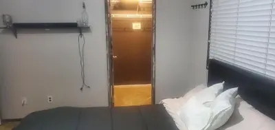 a bedroom with a bed with white pillows and a window at Galaxy House in Sun City