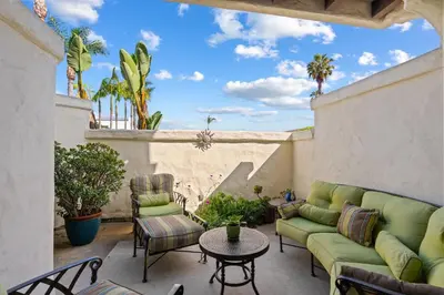 a patio with couches and a table and chairs at Carlsbad's Hidden Escape in Carlsbad