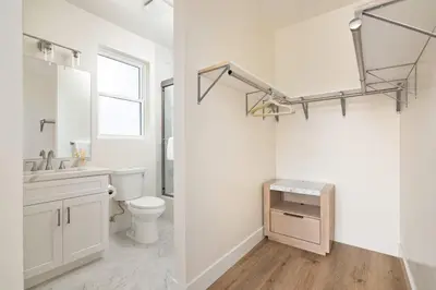 a white bathroom with a toilet and a sink at Airy Ocean Beach Home with Coastal Views in San Diego