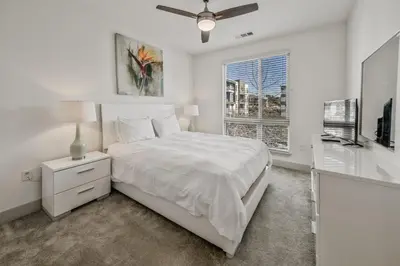 a white bedroom with a bed and a window at Global Luxury Suites Mission Valley East in San Diego