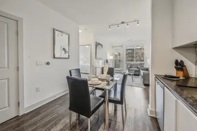 a kitchen and dining room with a table and chairs at Global Luxury Suites Mission Valley East in San Diego