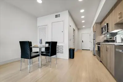 a kitchen with a table and chairs in a room at Global Luxury Suites near Liberty Station in San Diego
