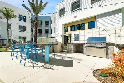 a patio with a table and chairs and a grill at Global Luxury Suites near Liberty Station in San Diego