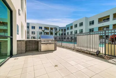 a patio with a grill in front of a building at Global Luxury Suites near Liberty Station in San Diego