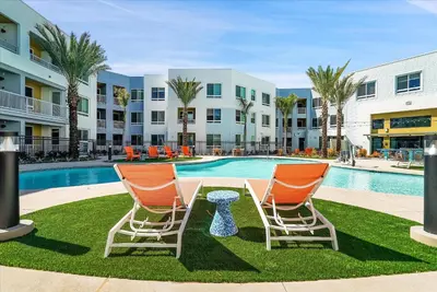 two chairs and a table in front of a pool at Global Luxury Suites near Liberty Station in San Diego