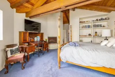 a bedroom with a bed and a desk and a computer at 4 Bedroom With Pool in Oceanside