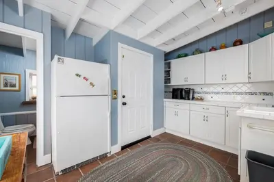 a kitchen with a white refrigerator and blue walls at 4 Bedroom With Pool in Oceanside