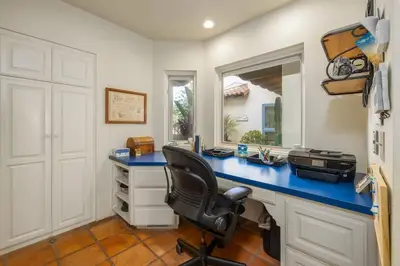 a home office with a blue desk and a chair at 4 Bedroom With Pool in Oceanside