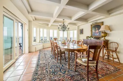a dining room with a table and chairs at 4 Bedroom With Pool in Oceanside
