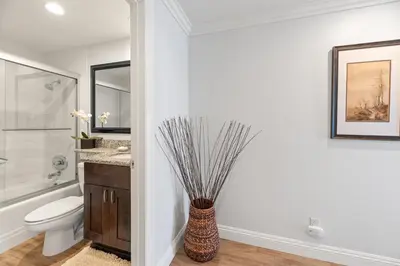 a bathroom with a toilet and a vase at Oceanfront La Jolla Cove Condo in San Diego