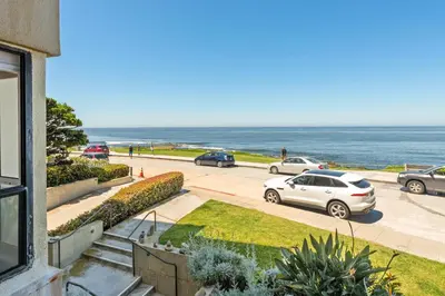 a car parked in a parking lot next to the ocean at Oceanfront La Jolla Cove Condo in San Diego
