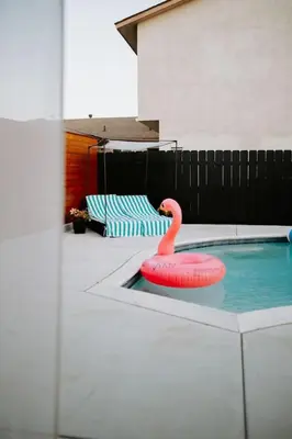 a pink flamingo toy in a swimming pool at Private Pool Chefs Kitchen BBQ 4min to SDSU in La Mesa