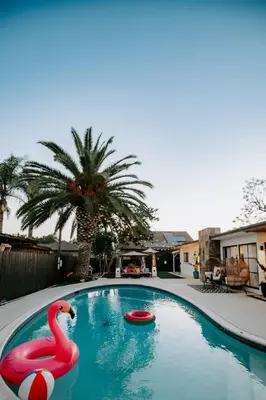 a swimming pool with a pink flamingo in the water at Private Pool Chefs Kitchen BBQ 4min to SDSU in La Mesa
