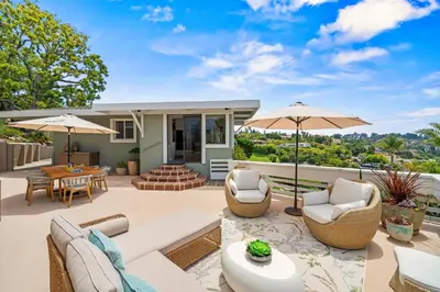 an outdoor patio with chairs and umbrellas at La Jolla Hilltop Haven with Ocean Views and Spa in San Diego