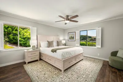 a bedroom with a bed and a ceiling fan at La Jolla Hilltop Haven with Ocean Views and Spa in San Diego