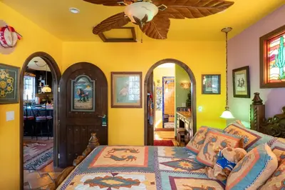 a bedroom with a bed and a ceiling fan at La Casita Private Resort Spa and Mini Golf Course in Alpine