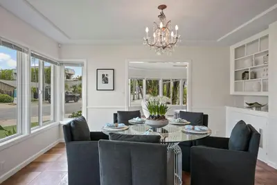 a dining room with a table and chairs and a chandelier at Stunning La Jolla Hideaway Close to Everything in San Diego