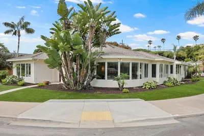 a house with a palm tree in front of it at Stunning La Jolla Hideaway Close to Everything in San Diego