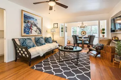 a living room with a couch and a table at Redwood Hollow Cottages in San Diego