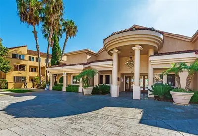 a large building with palm trees in front of it at --Vacation First floor luxury condo La Jolla, Spa, Pool, Gym in San Diego