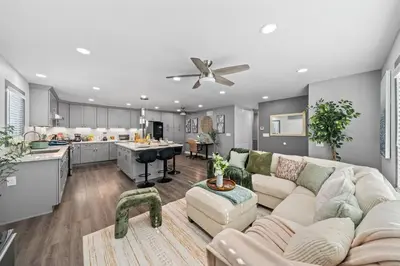 a living room with a couch and a kitchen at Entire Private Home with 4 Bedrooms 3 Bathrooms, King Bed, Gated Yard, Parking, Ranch, Available Now in San Diego
