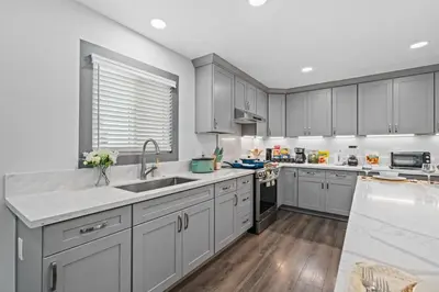 a kitchen with white cabinets and a sink at Entire Private Home with 4 Bedrooms 3 Bathrooms, King Bed, Gated Yard, Parking, Ranch, Available Now in San Diego