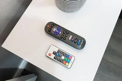 two remote controls sitting on top of a table at Entire Private Home with 4 Bedrooms 3 Bathrooms, King Bed, Gated Yard, Parking, Ranch, Available Now in San Diego