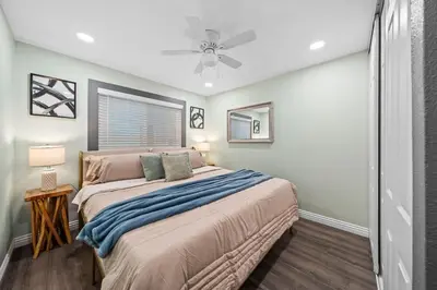 a bedroom with a bed and a ceiling fan at Entire Private Home with 4 Bedrooms 3 Bathrooms, King Bed, Gated Yard, Parking, Ranch, Available Now in San Diego