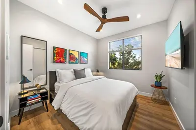 a bedroom with a bed and a ceiling fan at Del Mar Retreat - Laundry BBQ Firepit AC Patio in San Diego