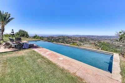 a swimming pool with a view of the mountains at Stunning Valley and Mtn Views Elegant Temecula Home in Temecula