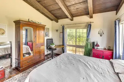 a bedroom with a bed and a desk and a window at Stunning Valley and Mtn Views Elegant Temecula Home in Temecula