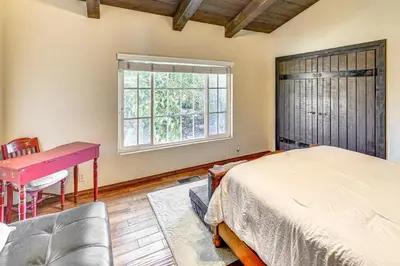 a bedroom with a bed and a desk and a window at Stunning Valley and Mtn Views Elegant Temecula Home in Temecula