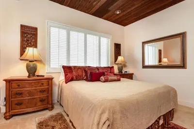 a bedroom with a bed and a large window at Luxury Oceanfront Home- Upper in Oceanside
