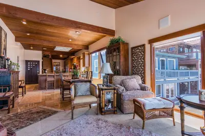 a living room with a table and chairs at Luxury Oceanfront Home- Upper in Oceanside