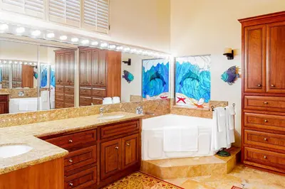 a bathroom with a large tub and a sink at Luxury Oceanfront Home- Upper in Oceanside