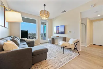 a living room with a couch and a chair at North Park Modern 2BR King Beds, Workspaces, Parking in San Diego